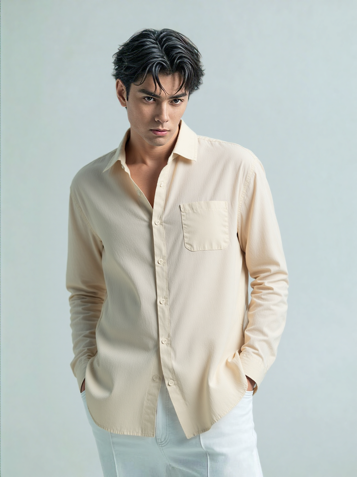 Man wearing a beige shirt against a light  background
